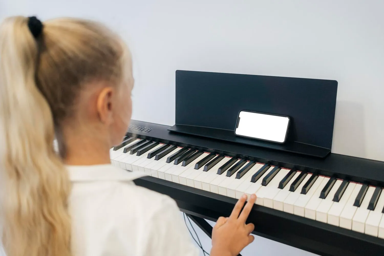 Clases de piano en Premià de Mar para niñas y niños Niña practicando piano durante unas clases de piano en Premià de Mar
